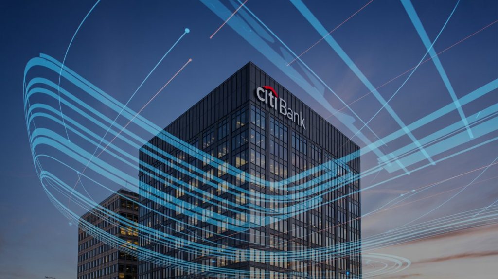 A Citi Bank office tower at dusk with glowing digital blue data lines flowing across the building, representing modernization and AI in Banking for global financial services.