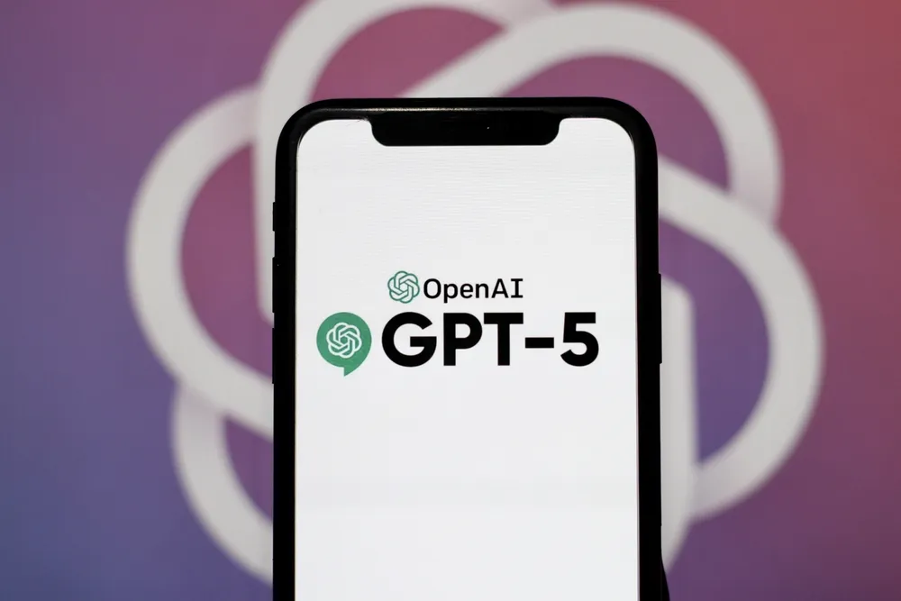Smartphone screen showing the OpenAI GPT-5 logo in front of a blurred background, used in an article comparing GPT-5.1 with GPT-5.