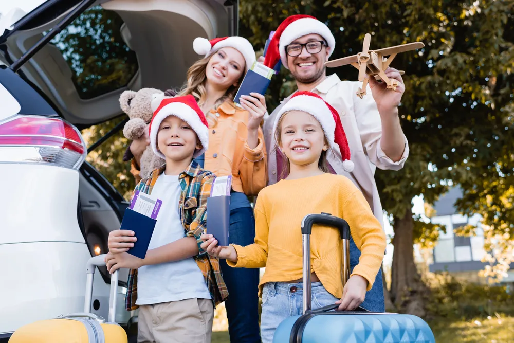AI Christmas family preparing for a holiday trip, parents and two children in Santa hats standing by a car with luggage and passports