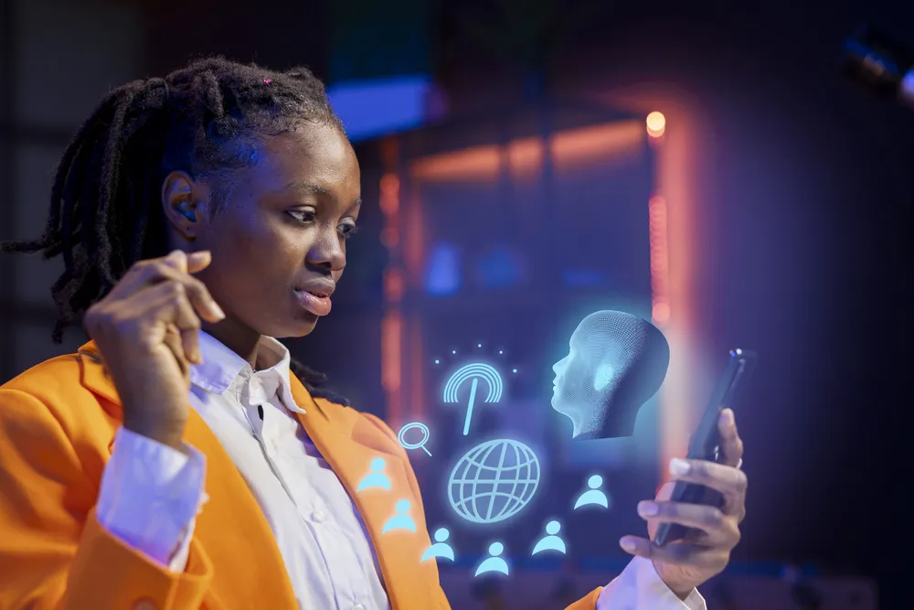 Person in an orange blazer looking at a smartphone with hologram icons, illustrating AI predictions about identity, security, and digital assistants.