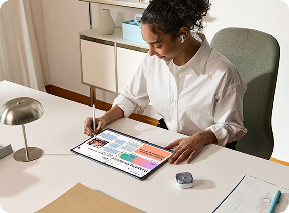 Woman using a Samsung tablet with stylus to interact with Galaxy AI features for writing and productivity tasks.