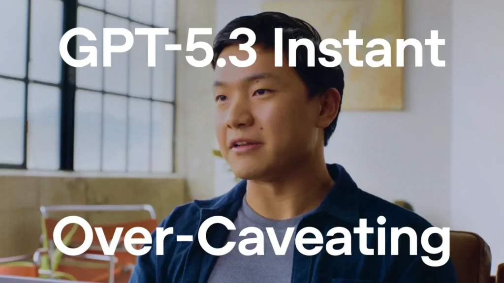 GPT-5.3 Instant Over-Caveating text over a man speaking in a bright office