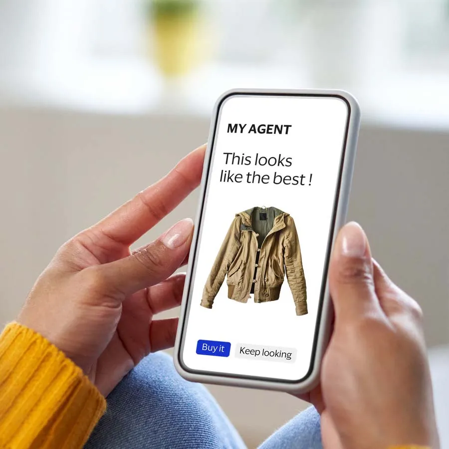 Smartphone showing an AI shopping agent recommending a jacket, illustrating how Intelligent Commerce can help buyers compare products and move toward checkout.
